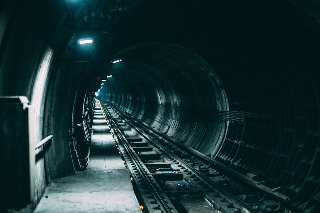 Dimly lit railway tunnel creates a dramatic and mysterious atmosphere.